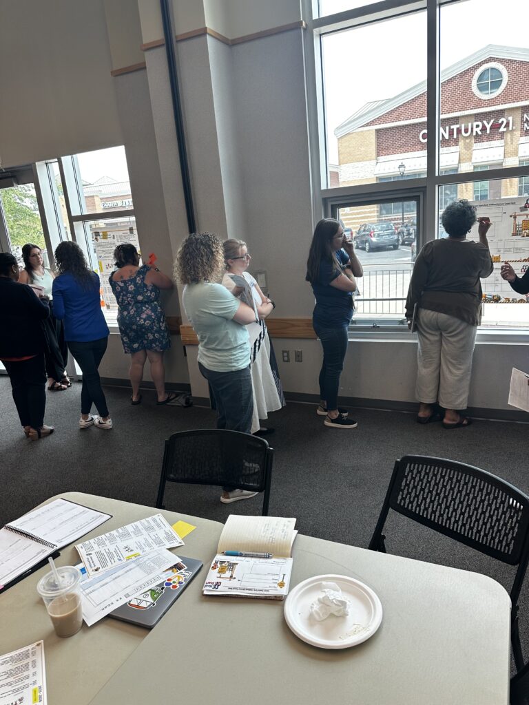 Small groups working on annual goals and a community events calendar during the Calvert County Early Childhood Advisory Council planning meeting